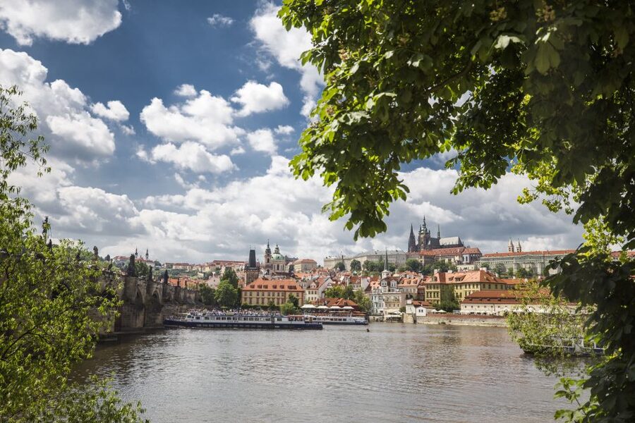 Prague: 3–Hour Castle Grounds Walking Tour and River Cruise - Crossing into Malá Strana: Red Roofs, Baroque Shapes, and the Shift in Mood