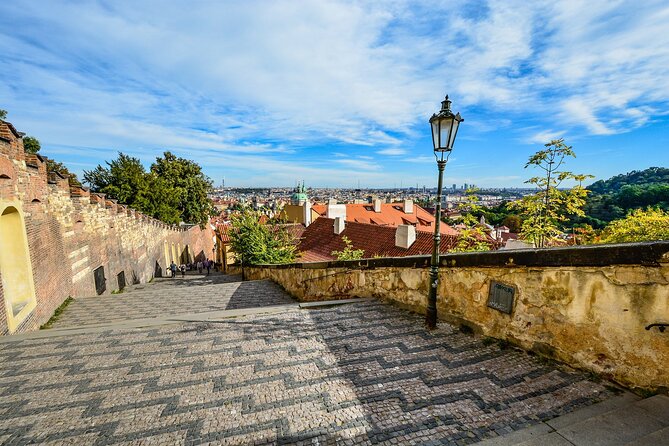 Prague DeLuxe Tour: Views, Hidden Gems, Tastings & River Cruise - Tram up, Lesser Town down: Malá Strana and the Infant Jesus of Prague
