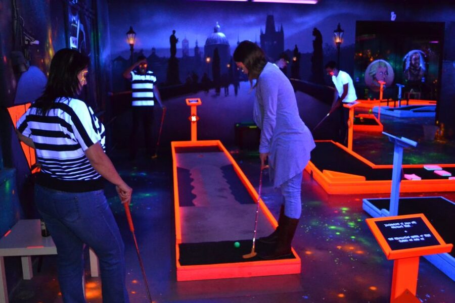 Prague: Glow Golf Mini Golf Game by UV Light - Czech-themed murals and the story vibe behind the neon