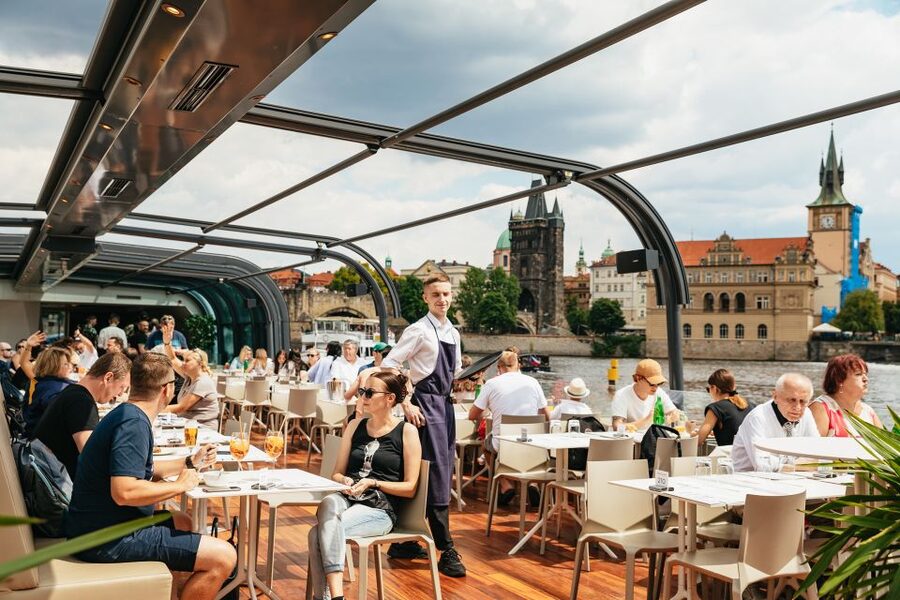 Prague: Vltava River Lunch Cruise in an Open-Top Glass Boat - Boarding and the onboard rhythm: QR code, drinks, and an accordion focus